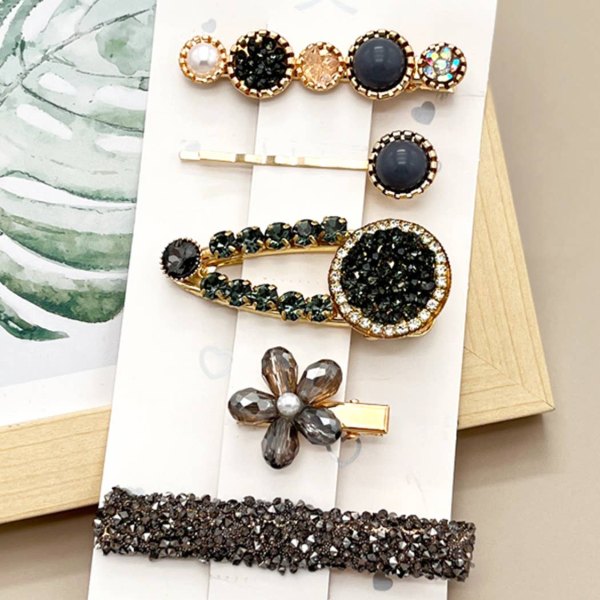 Five faux pearl hair clips in assorted colors
