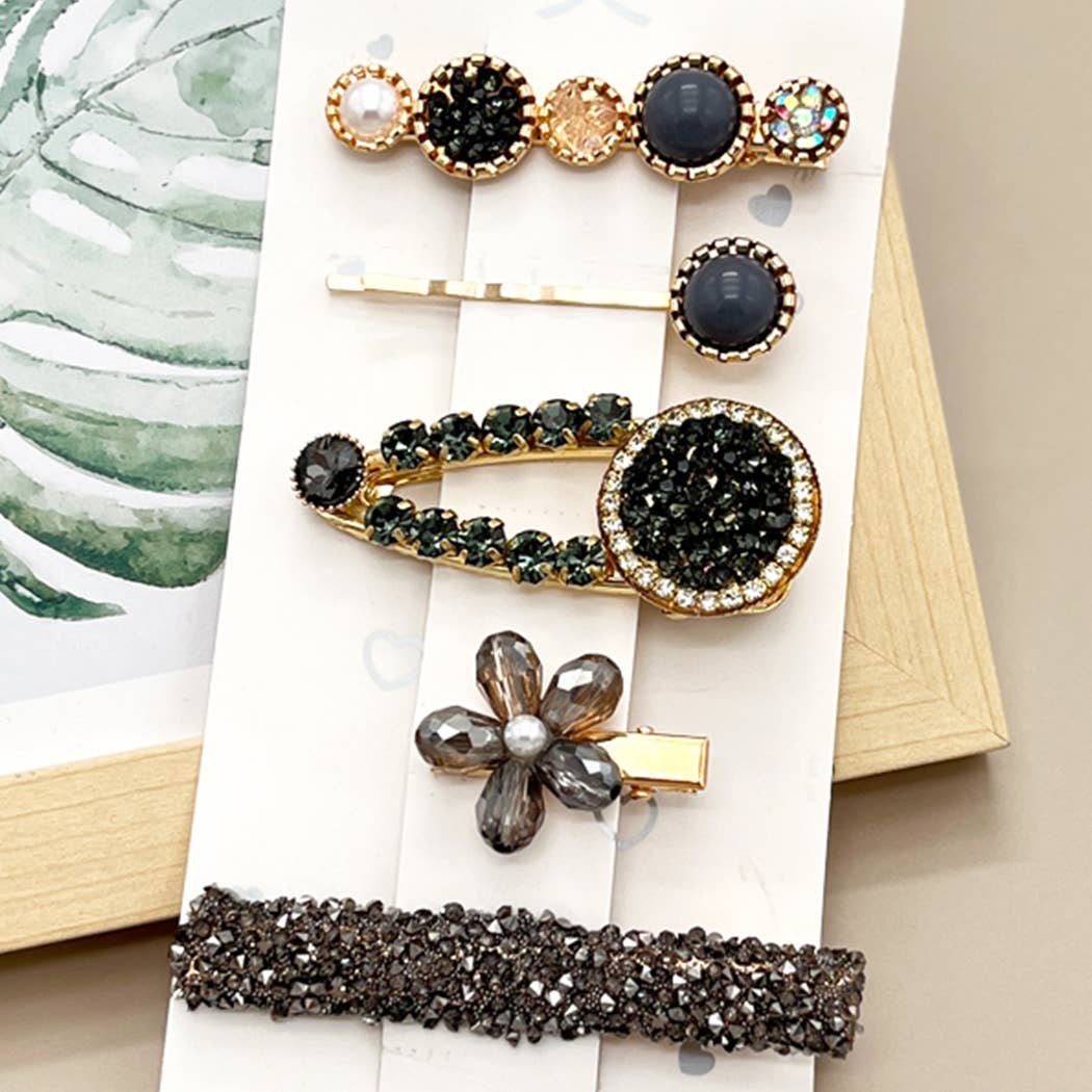 Five faux pearl hair clips in assorted colors