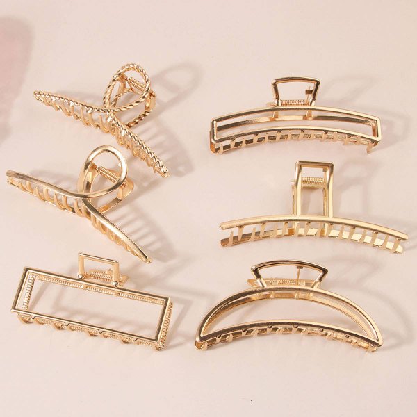 Gold tone claw clip set on a white surface
