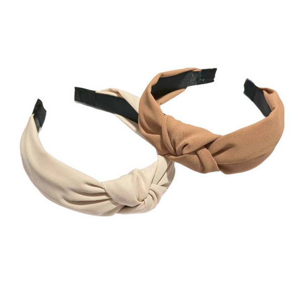 Knotted wide headbands in cream and tan on a white surface