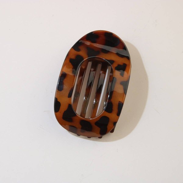 Tortoiseshell oval duckbill hair clip on a white background