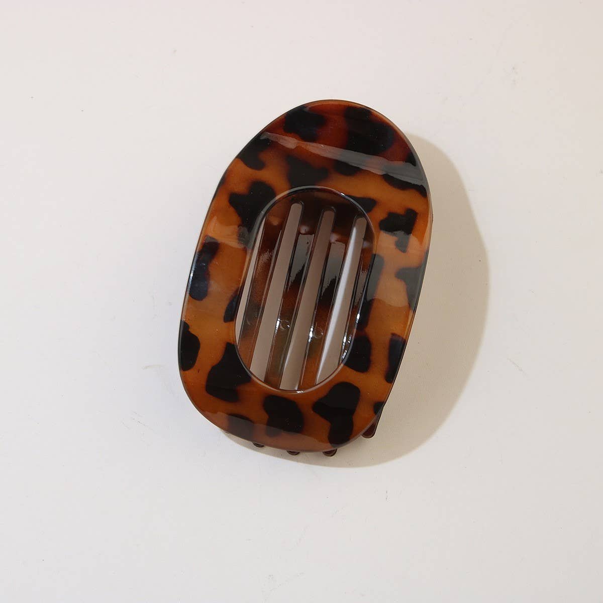 Tortoiseshell oval duckbill hair clip on a white background