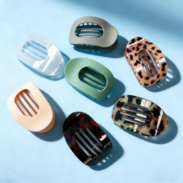 Oval duckbill hair clips in leopard, sage, cream and clear on blue