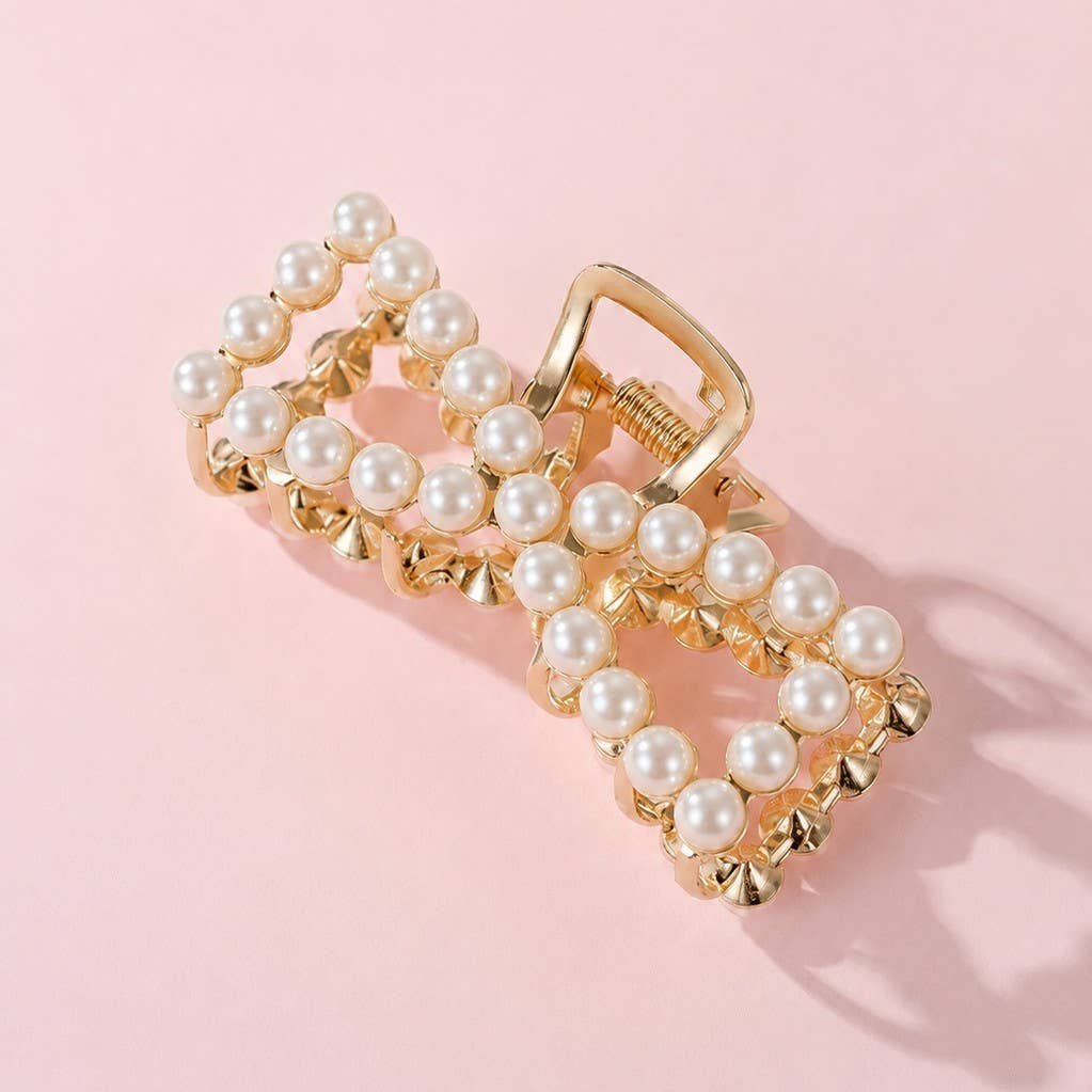 Gold tone claw clip with pearl set bow