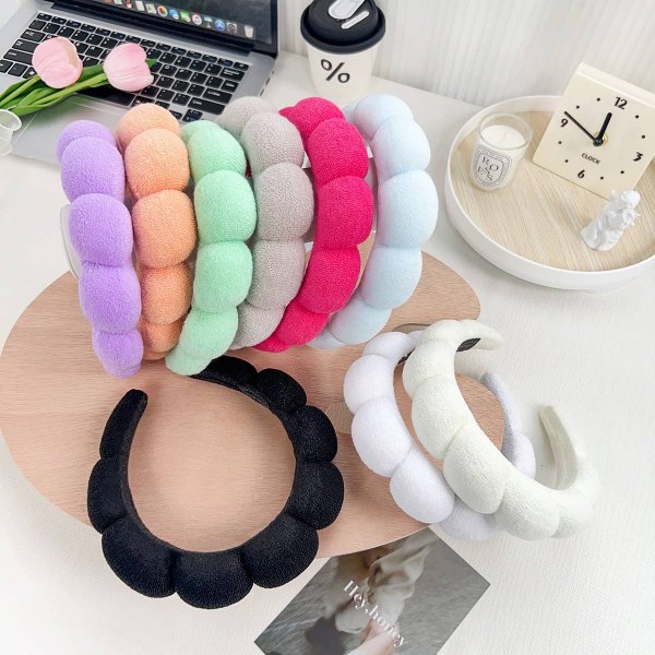 Row of plush spa headbands in pastel and neutral colors